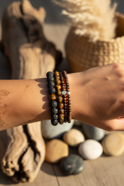 Lava stone and tiger eye bracelet set stacked on a wrist with earthy textures